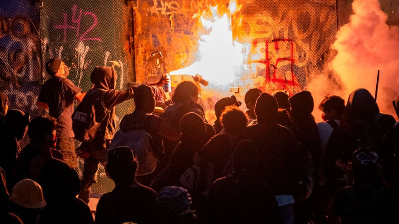 Manifestantes frente a una barrera durante la marcha del 2 de octubre